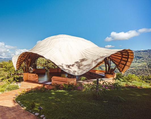 The bamboo Air Temple at Holos Basecamp, an open-air structure overlooking the Diamante Valley